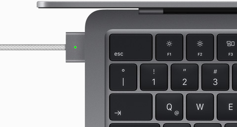 Imagen desde arriba de un cable MagSafe conectado a un MacBook Air gris espacial