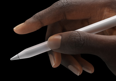 A user holds Apple Pencil Pro in between thumb and forefinger.