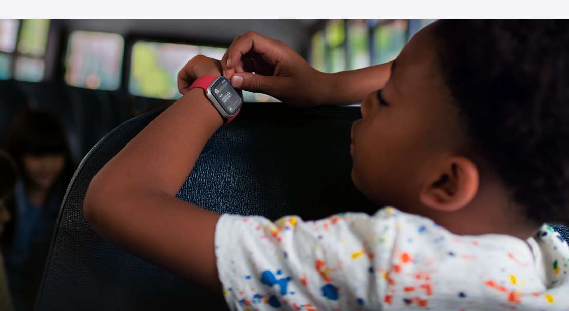 A child reading a text on Apple Watch SE.