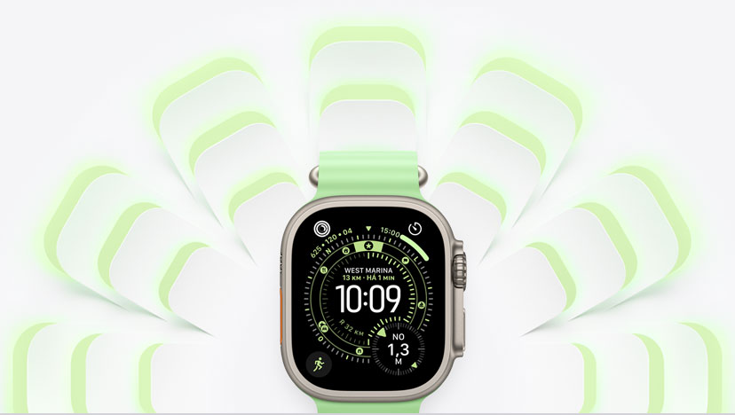 Apple Watch Ultra 3 com caixa natural de titânio e pulseira Oceano verde-néon, a Digital Crown, grafismos na mesma cor da pulseira irradiam ao fundo