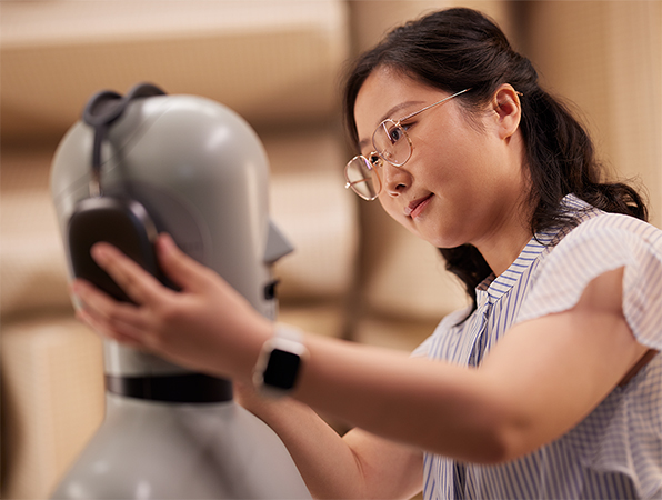 Une employée de l’équipe Matériel d’Apple teste en laboratoire le casque AirPods Max sur un mannequin.