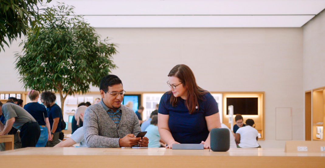 Melissa, an Apple Store Genius, helps a customer resolve an issue with his iPhone.