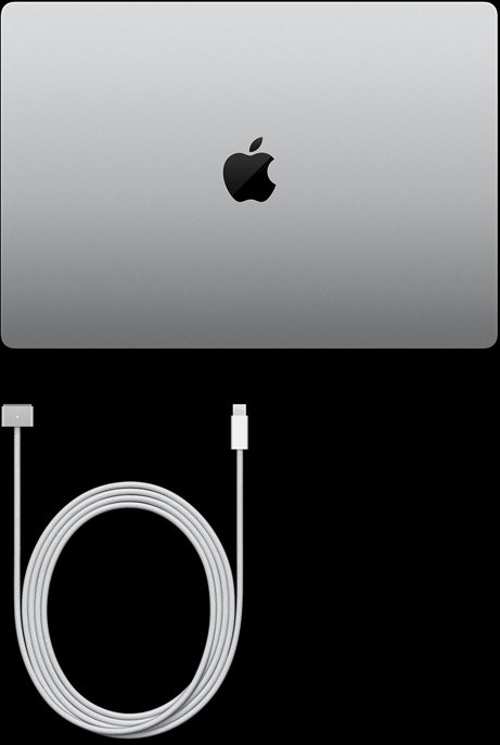 MacBook Pro, silver colour, top, closed, next to charging cable and adapter