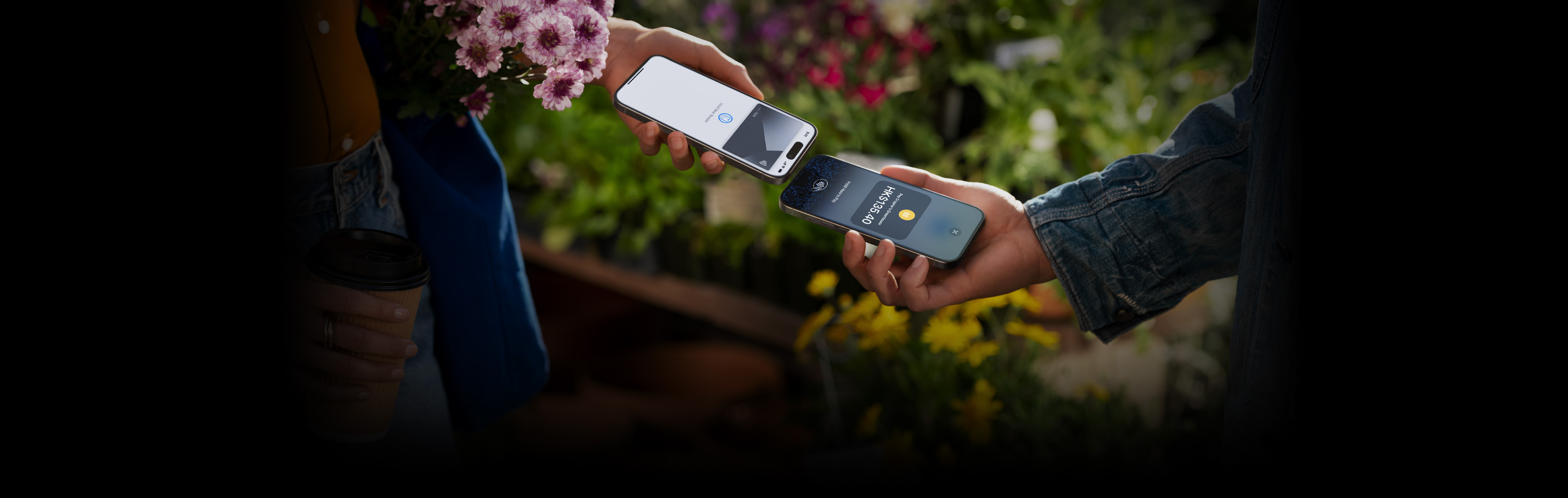 An image of two people holding their iPhone devices together completing a transaction.