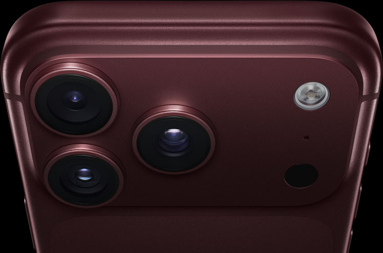iPhone 18 Pro, burgundy finish, partial back exterior angled to show pro camera system in top left corner, 3 lenses, microphone, flash