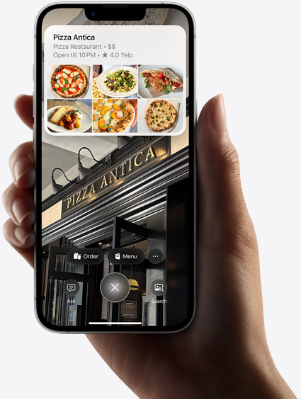 Hand holding iPhone 16e showing results of a search using visual intelligence.