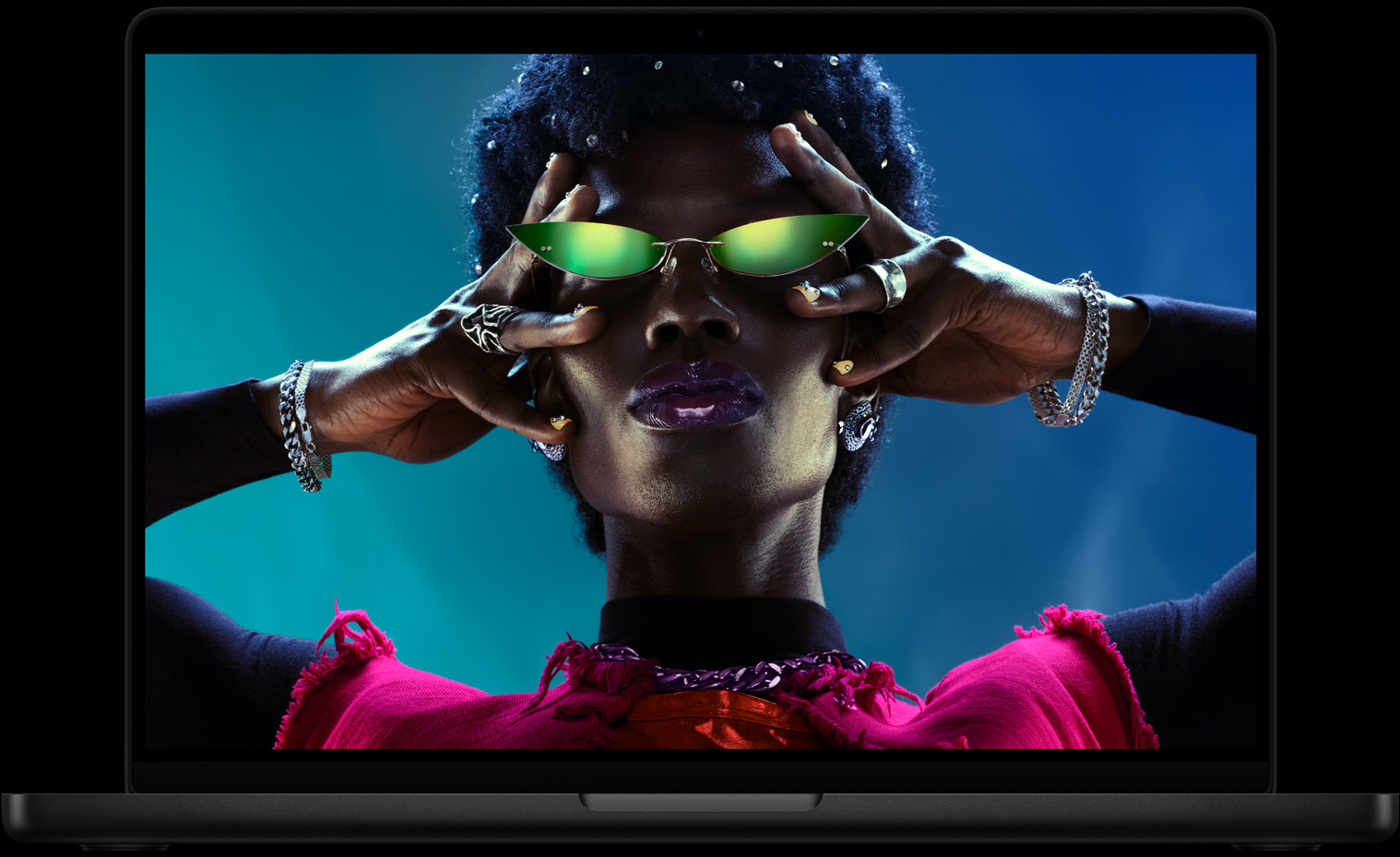 Colorful screen on a MacBook Pro of a person wearing sunglasses, showcasing the vibrant Liquid Retina XDR display