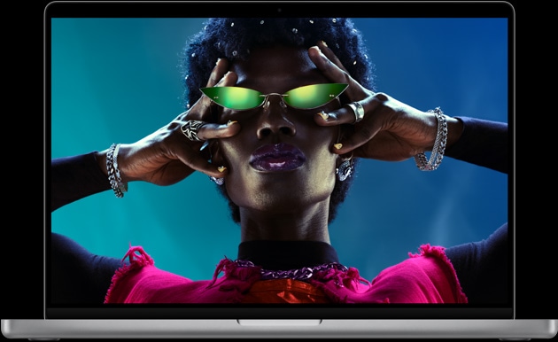 MacBook Pro, silver color, open, display shows image of person