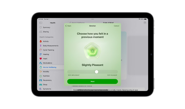 Widok z przodu na ustawnionego poziomo iPada mini. Na ekranie apka Zdrowie, wybór oznaczeń do notowania nastroju.