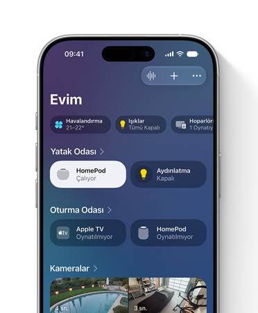 Ev uygulamasının gösterildiği iPhone ekranı, Evim görünümü, Yatak Odası ve Oturma Odası için ışıklar ve HomePod hoparlörler gibi aksesuarları temsil eden kutucuklar
