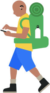 Person with hiking backpack wearing hearing aid and looking down at an iPhone in their hand