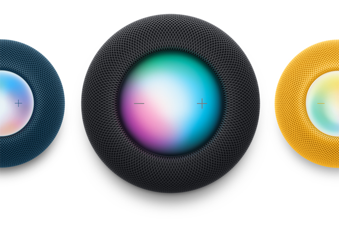 A Blue HomePod mini, a Midnight HomePod, and a Yellow HomePod mini shot from the top down. Siri is activated.
