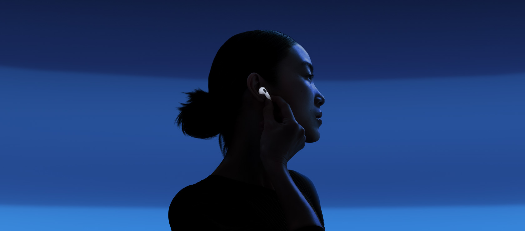 A person enabling Active Noise Cancellation by touching the stem of AirPods 5