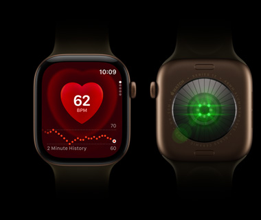 Two Apple Watch Series 12 devices side by side; Front-view of Apple Watch Series on left, screen displays heart rate monitor; Back-view of Apple Watch Series 12 on right, lights shine bright, colour green