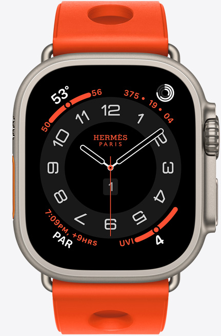 Apple Watch Hermès Ultra 3, cadran analogique Circulaire, (aiguilles des heures, des minutes et des secondes, complications: Météo, anneaux Activité, heure de Paris et Indice UV), boîtier en titane, finition naturelle, côté droit, Digital Crown, bouton latéral en saillie, associée au bracelet Scub’H Diving, orange néon (orange vif), caoutchouc moulé, découpes circulaires centrées