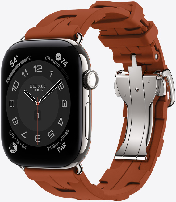 Apple Watch Hermès Series 12, Circulaire analog watch face, (hour, minute and second hands, complications: Weather, Noise, Activity rings, and Paris time), titanium case, silver color, right side exterior, Digital Crown, side button, paired with Kilim Single Tour band, cuivre color (brown), molded rubber material, geometric interlocking design, silver-colored metal clasp
