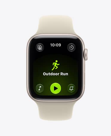Apple Watch SE 3, aluminum case, starlight color, screen shows Workout app (outdoor run), right side exterior, Digital Crown dial, Sport Band, sand color (light tan)
