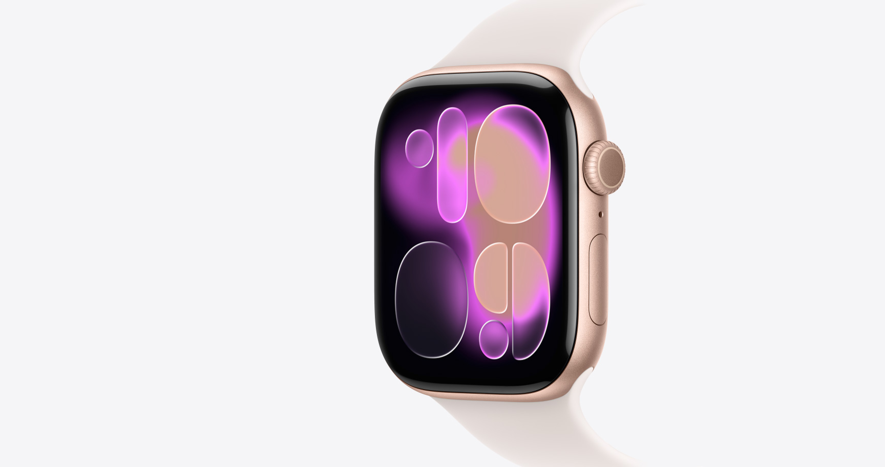 Apple Watch Series 11 z kopertą z aluminium w kolorze różowego złota, pasek sportowy w kolorze łagodnego różu tarcza Lawa, widoczny prawy bok urządzenia, pokrętło Digital Crown, mikrofon, przycisk boczny