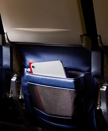 An iPad Air in Silver colour left behind in a passenger seatback pocket