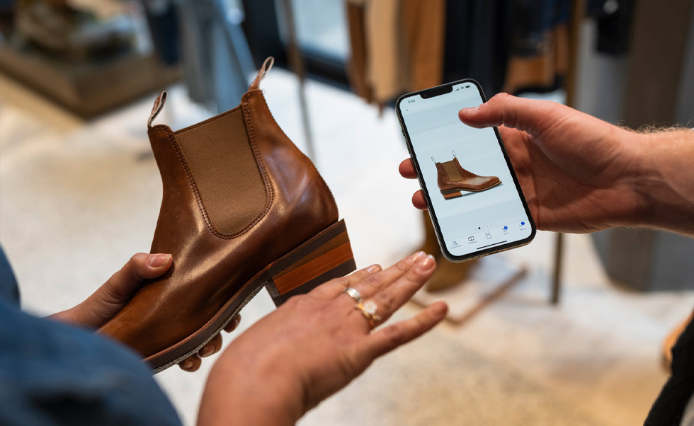 Ein Mitarbeiter überprüft mit der iOS App NewStore den Lagerbestand.