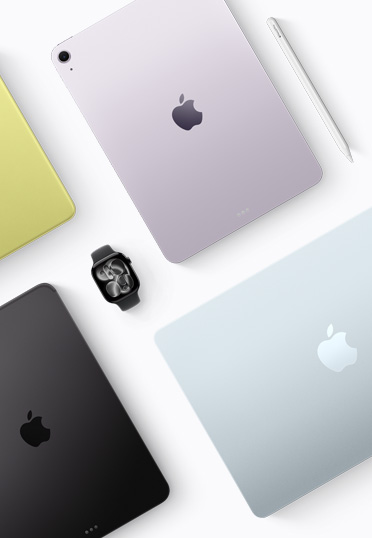 A top down view of different coloured Mac and iPad devices, with a black Apple Watch in the centre.