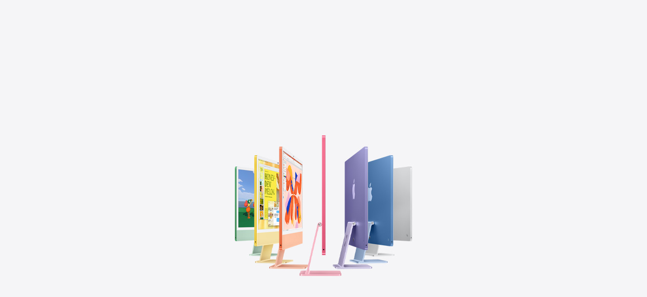 Seven iMac models in colors green, yellow, orange, pink, purple, blue, and silver, in an accordion arrangement