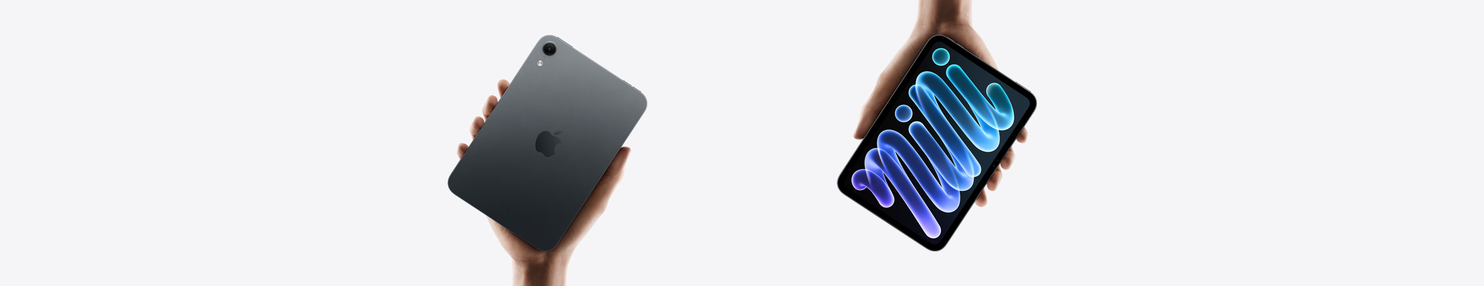 iPad mini, black, held in hand, back view