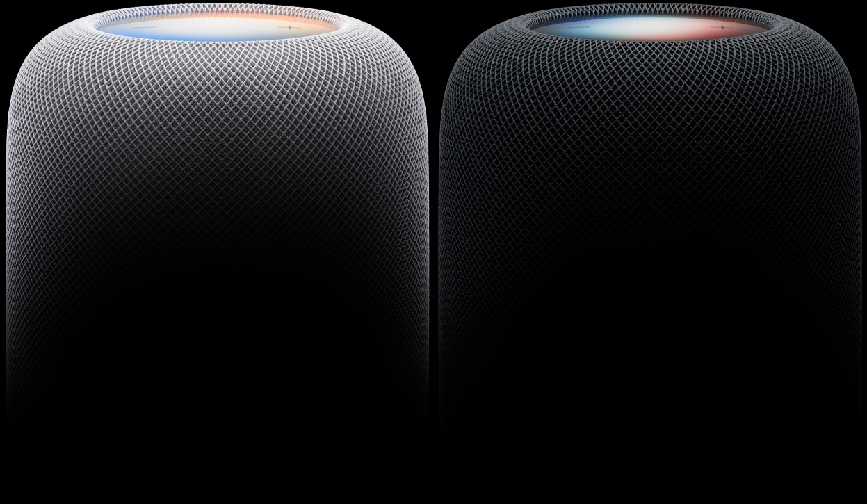 Two HomePod speakers side by side, white color and midnight color, woven acoustic mesh fabric, illuminated touch surfaces