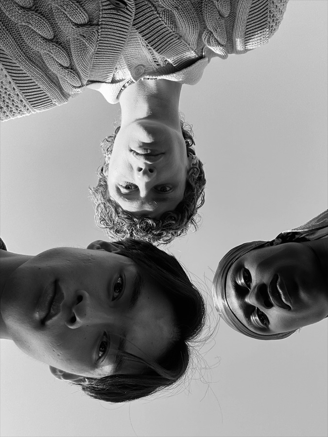 A group selfie of three people at varying distances from the camera. The photo was taken on the TrueDepth camera.