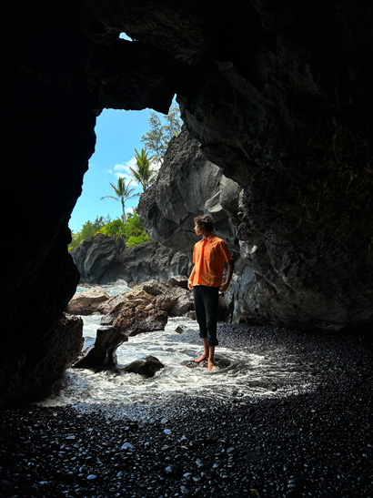 A photo of someone in the entrance of a cave, taken with the Ultra Wide camera.