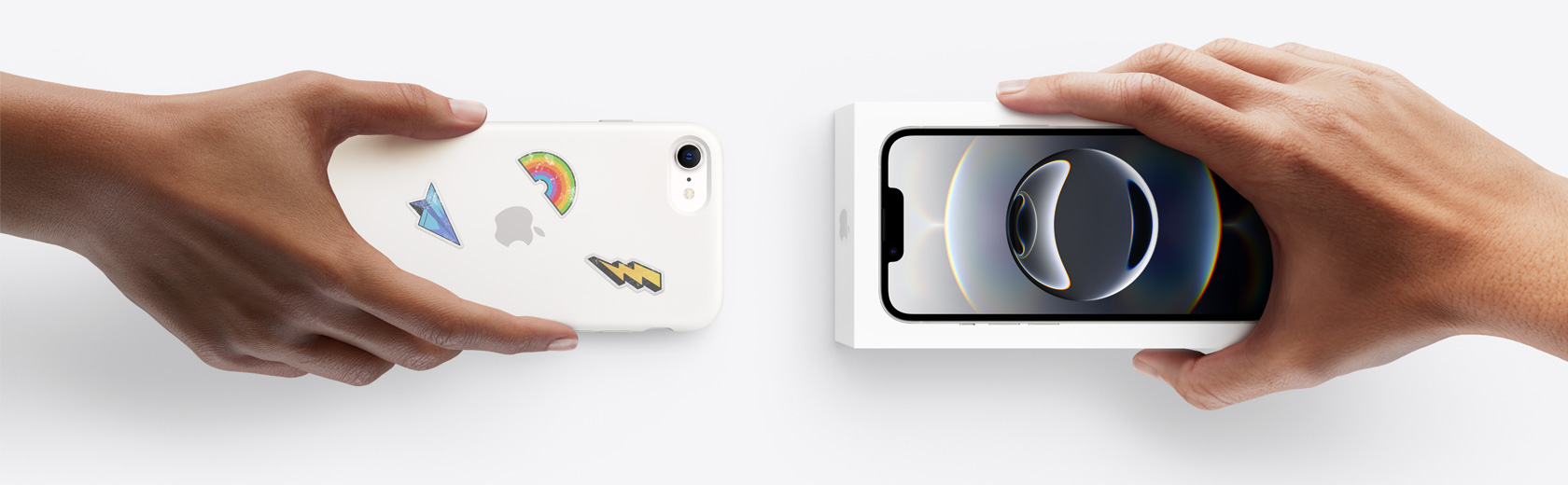 Hands exchanging trade-in iPhone for iPhone 16e in box.