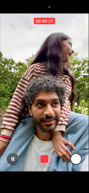 iPhone 17 screen demonstrating stabilised video recording as man carries girl on his shoulders