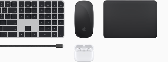 Collection of accessories including Magic Keyboard with Touch ID, Magic Mouse, Magic Track Pad, Thunderbolt 5 Pro cable and AirPods Pro