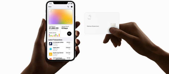 One hand holding an iPhone with financial information on screen and other hand holding an Apple Card