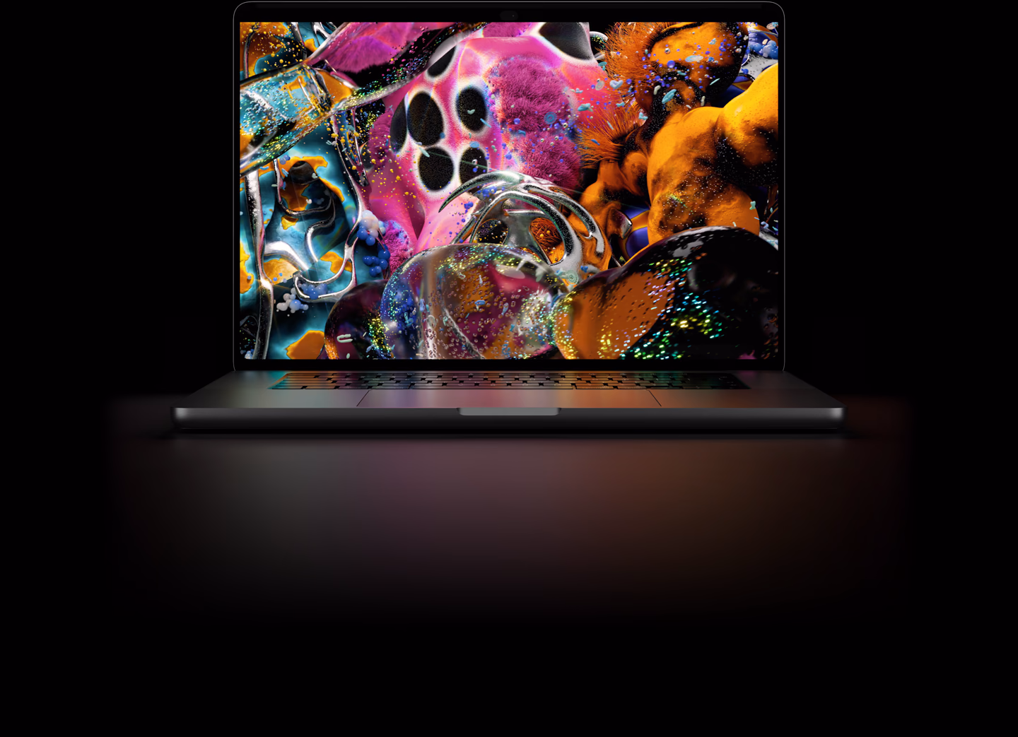 MacBook Pro with PROLED XDR Display, space black colour, display shows a detailed image with high contrast and vivid colours, screen illuminates keyboard