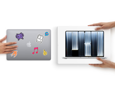 A hand slides a MacBook with stickers on the front towards two hands holding a new MacBook in the box