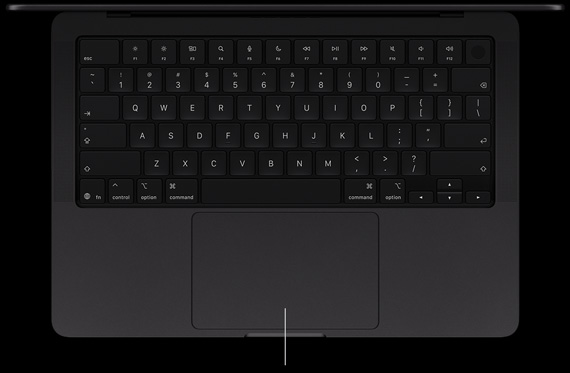 MacBook Pro with PROLED XDR Display, space black colour, open, showing keyboard and Force Touch trackpad