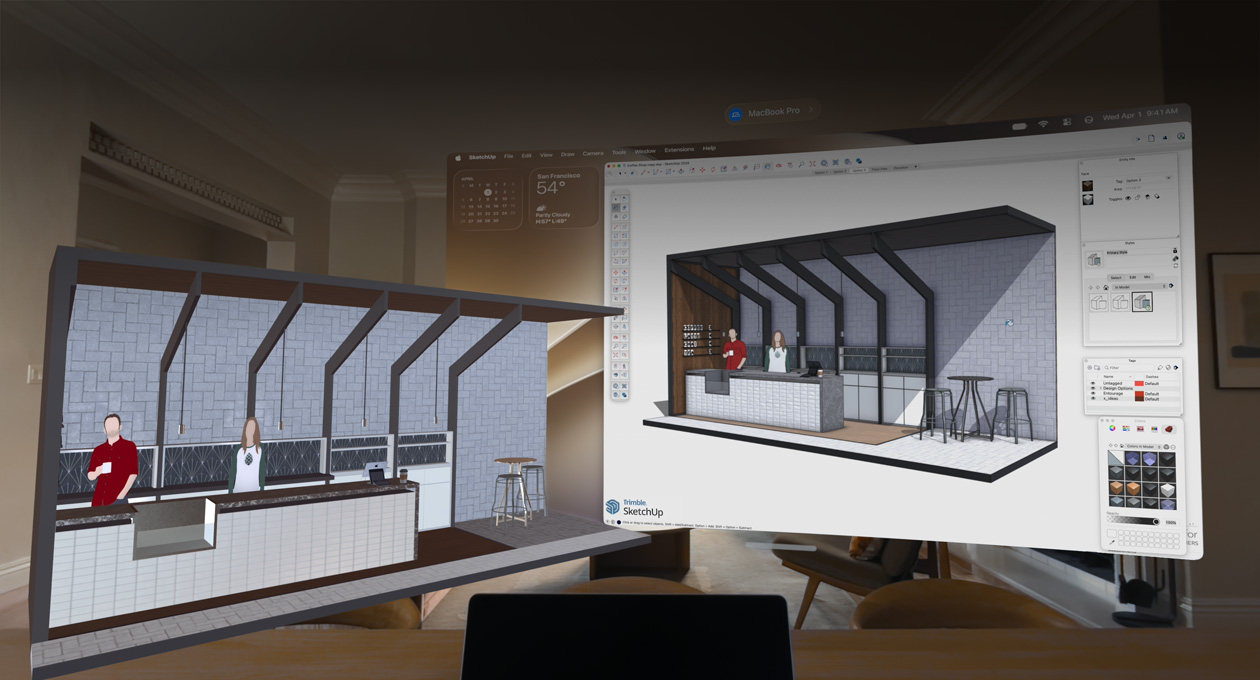Apple Vision Pro view, MacBook Pro sits on a surface with 3D models projected behind it, models show a café service counter with two people standing behind it
