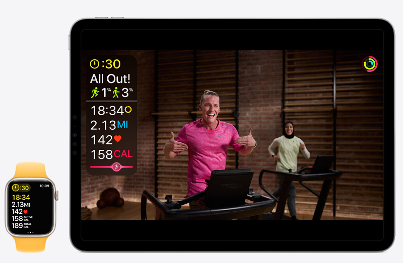 An iPad Pro showing an Apple Fitness+ workout next to an Apple Watch Series 9 tracking that same Apple Fitness+ workout.
