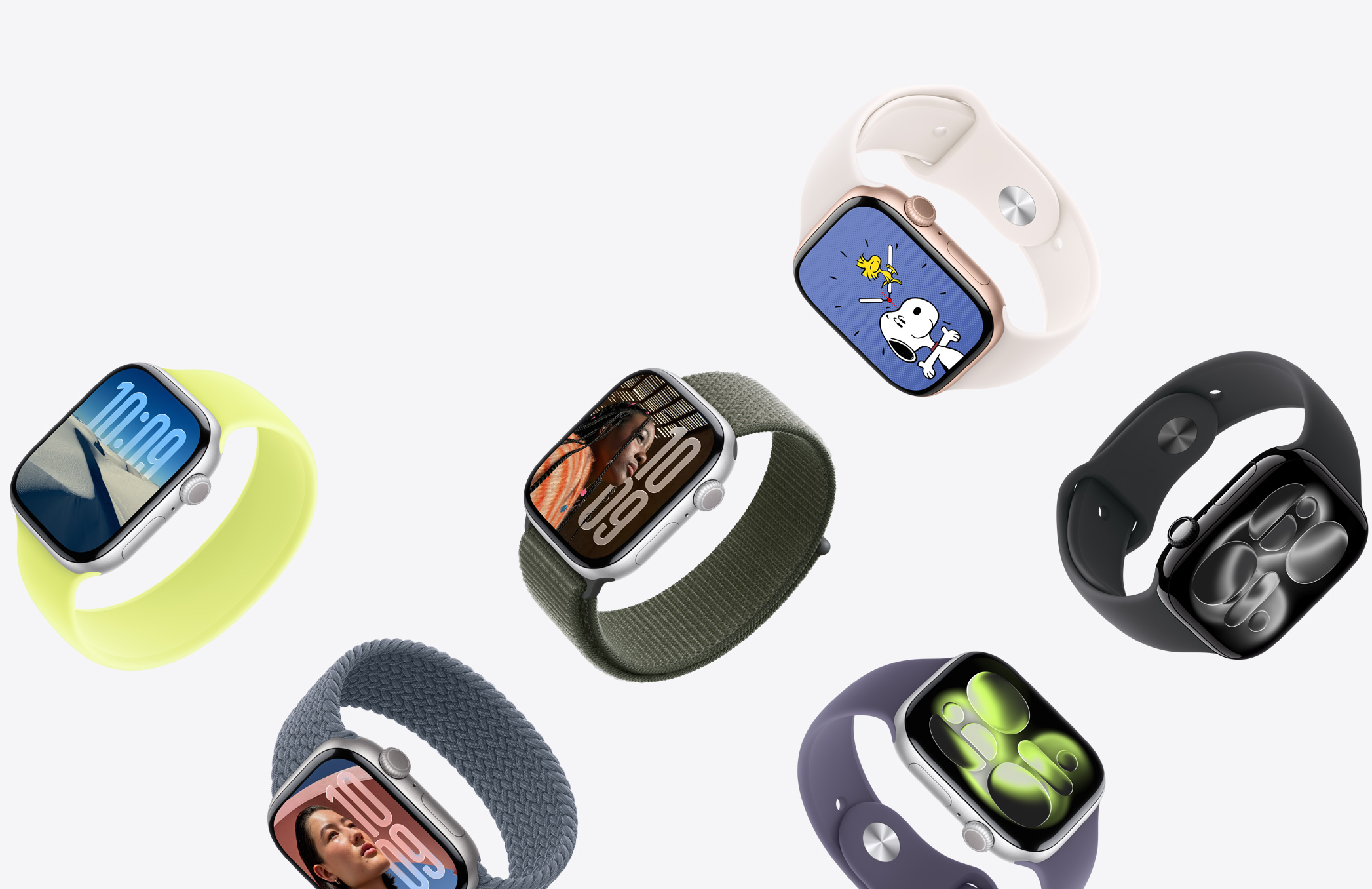A selection of Apple Watch devices with different case finishes and a variety of strap colours and materials.
