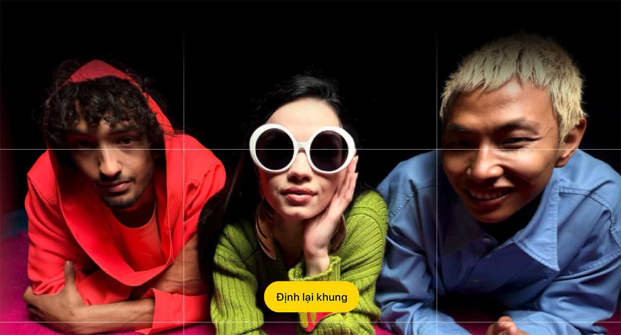 Brightly hued close-up photo of three people looking at the camera, button reads “Reframe.”